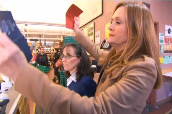 Samantha Bee shows her passport to the Park Slope Food Co-op folks